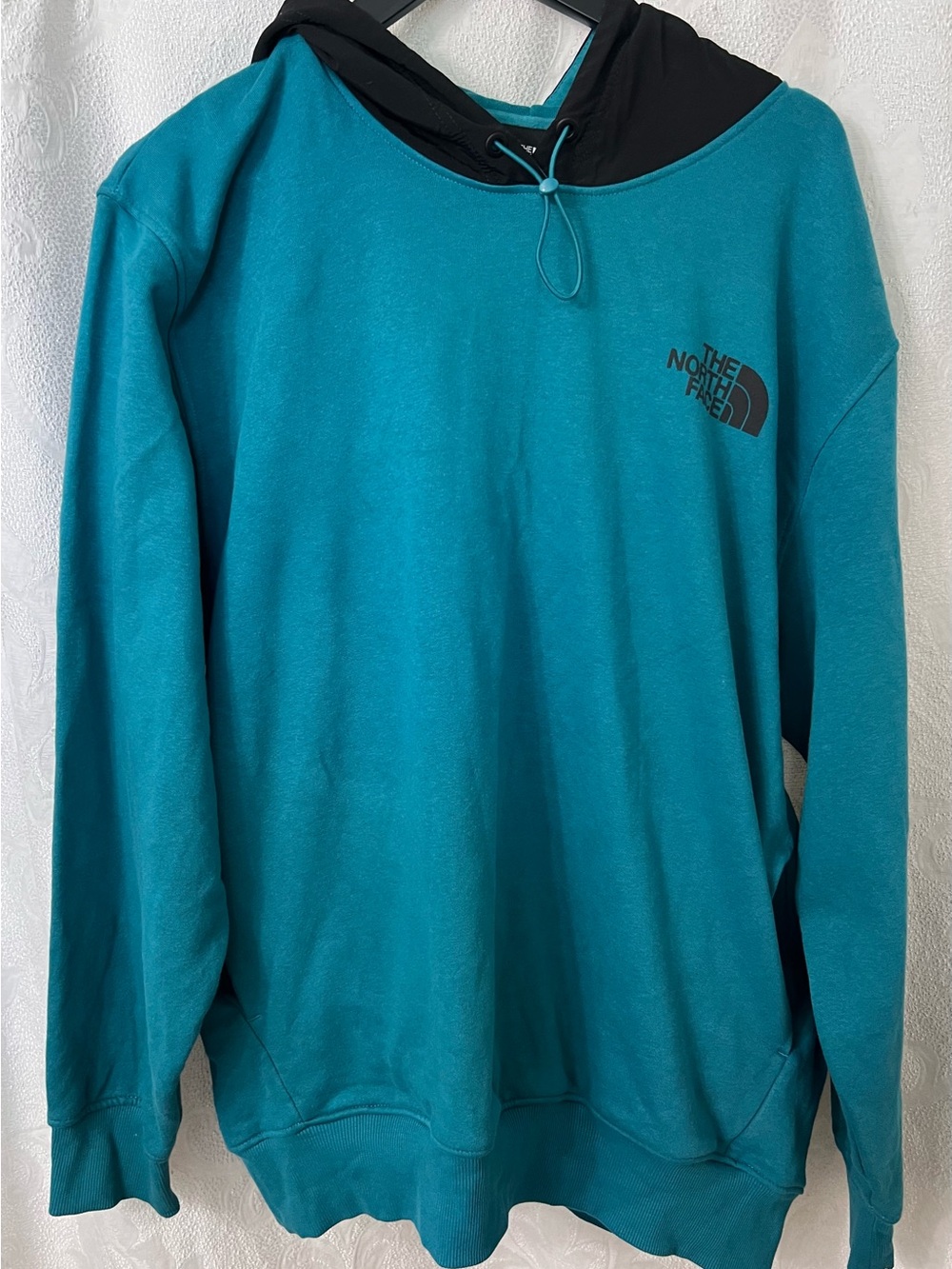 The North Face  Me's Teal Hoodie pullover with Black Hood snd pockets size XL.